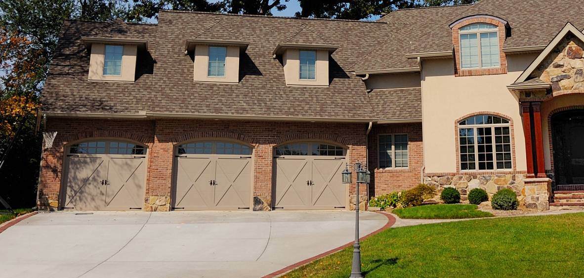 Cape cod overlay carriage house garage door in sandstone